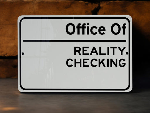 a white sign that says office of reality checking