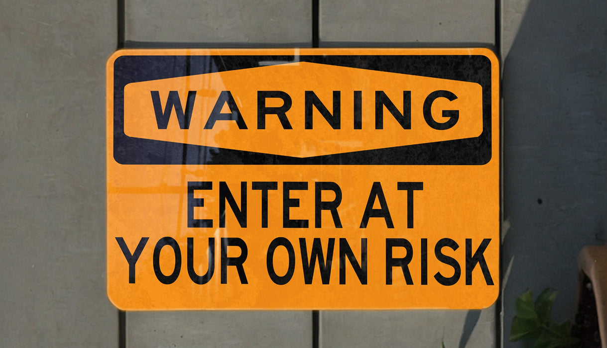 a yellow and black street sign on a wall