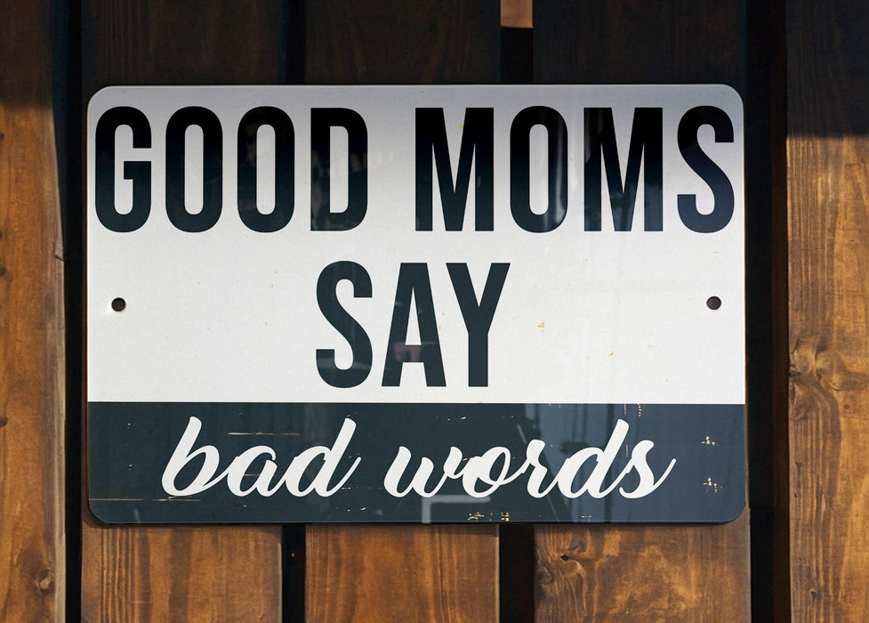 a white and black street sign on a wooden fence