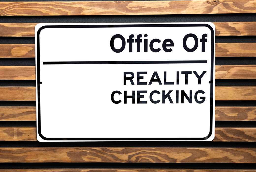 a close up of a sign on a wooden bench