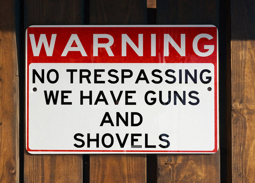 a red and white sign on a wooden fence
