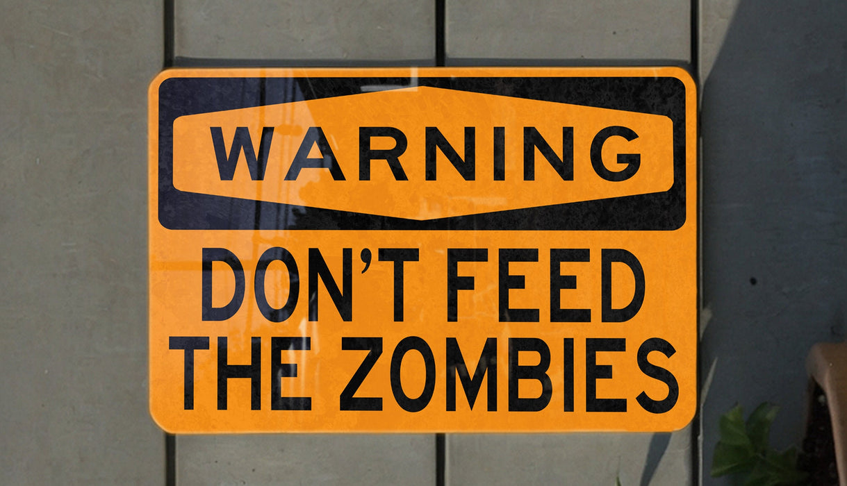 a yellow and black sign that says the zombies don't feed my dying