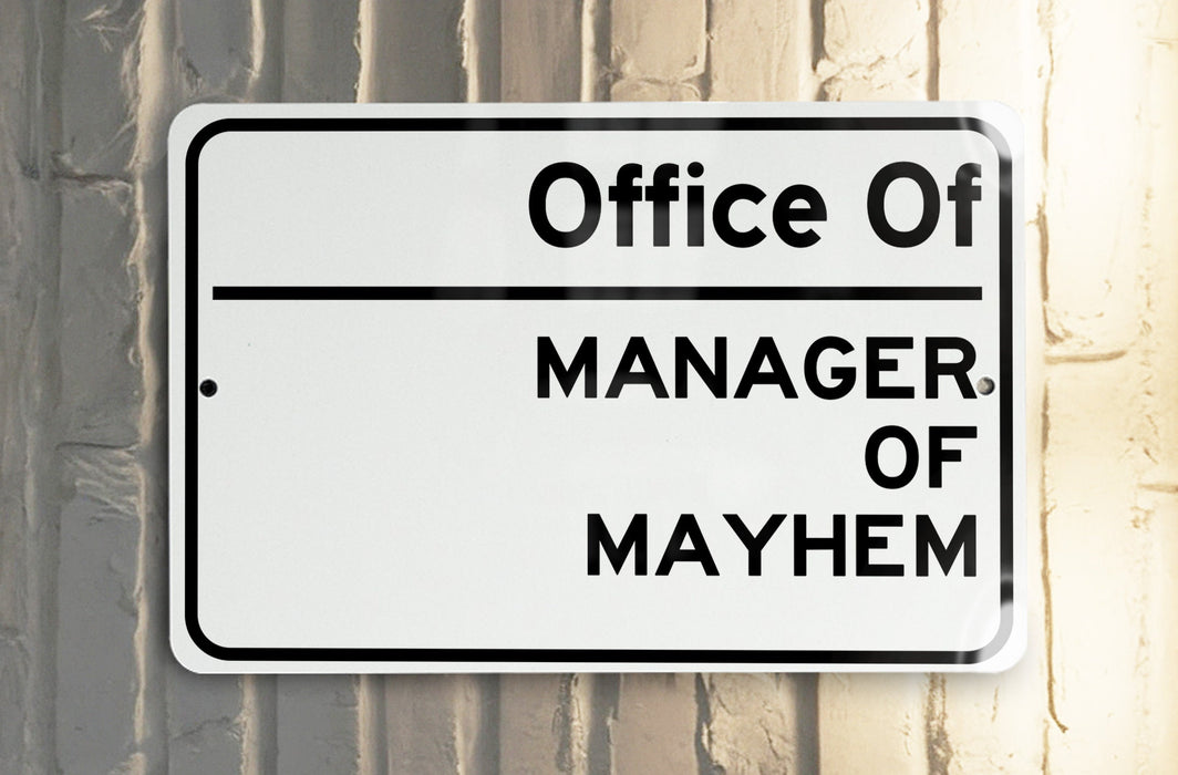 a white and black street sign on a pole