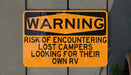 a yellow and black warning sign on a wall