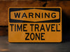 a yellow sign warning of time travel zone