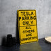 a yellow sign that says tesla parking only all others are unworthyly