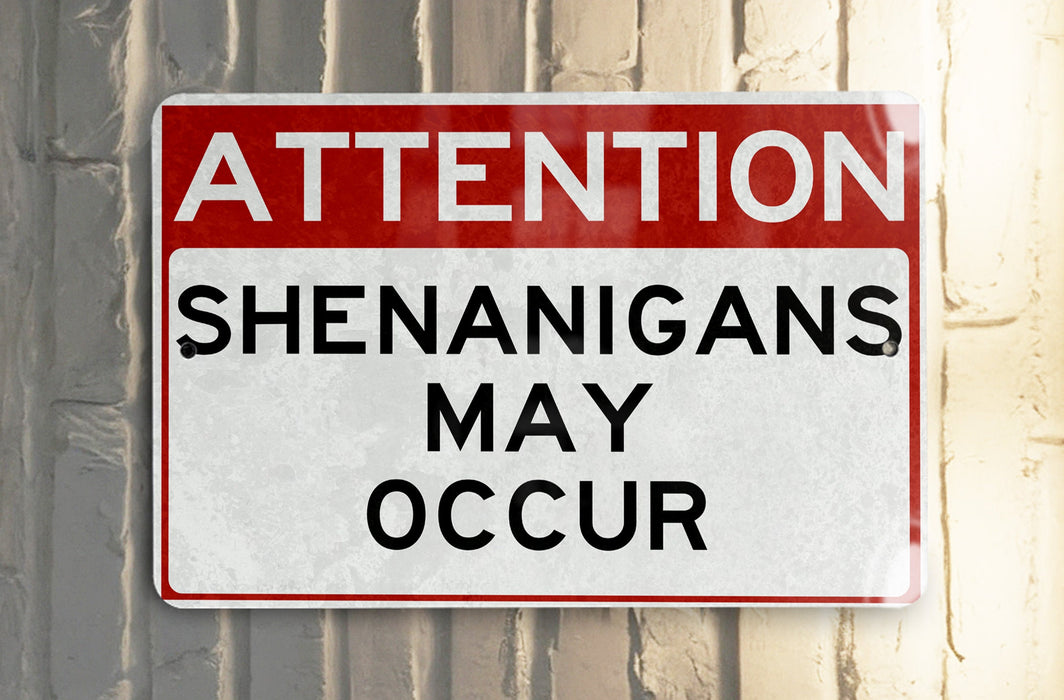 a red and white street sign hanging from a metal pole