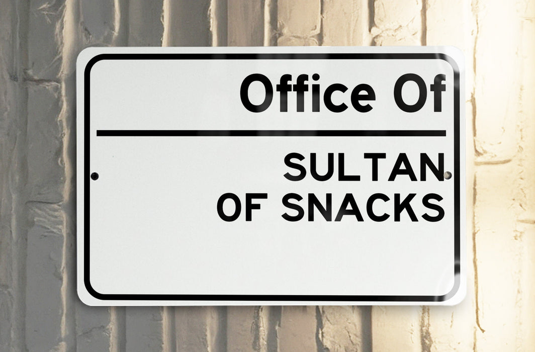 a white street sign hanging from the side of a building