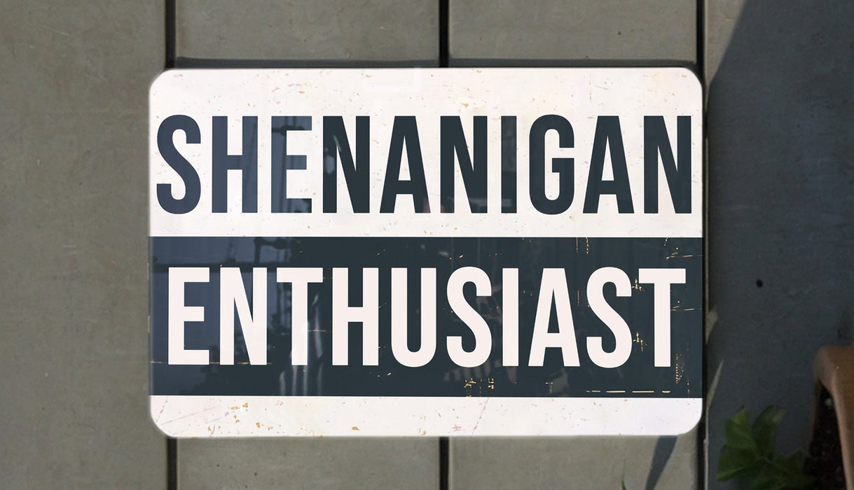 a white and black street sign hanging from the side of a building