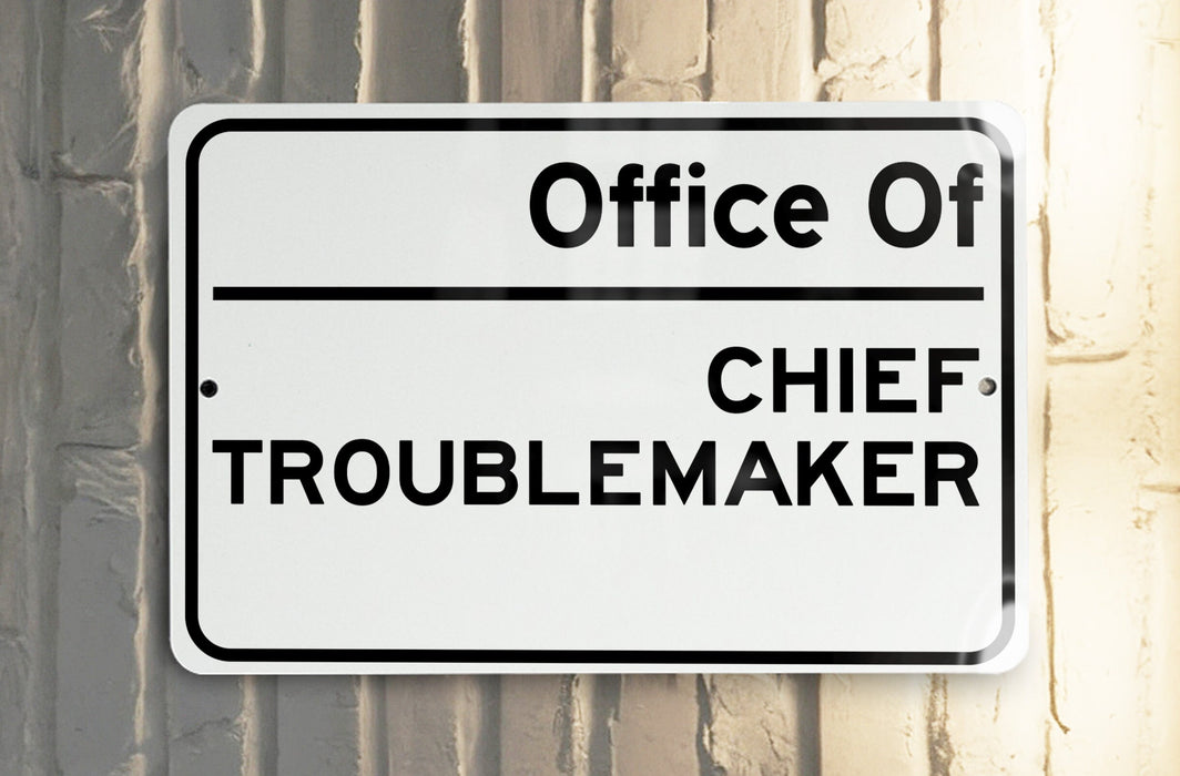 a white and black street sign on a pole