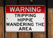 a red and white sign on a wooden fence