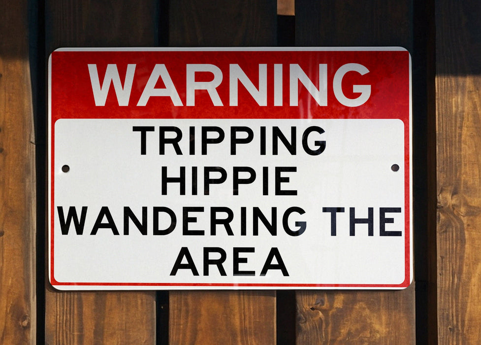 a red and white sign on a wooden fence