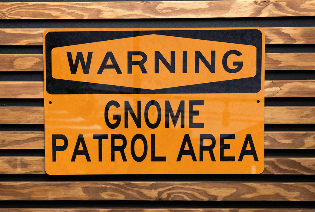 a yellow and black sign on a wooden wall