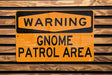 a yellow and black sign on a wooden wall