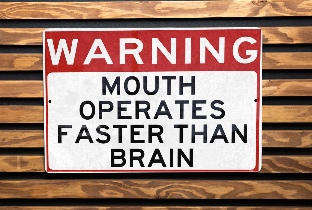a red and white sign on a wooden bench