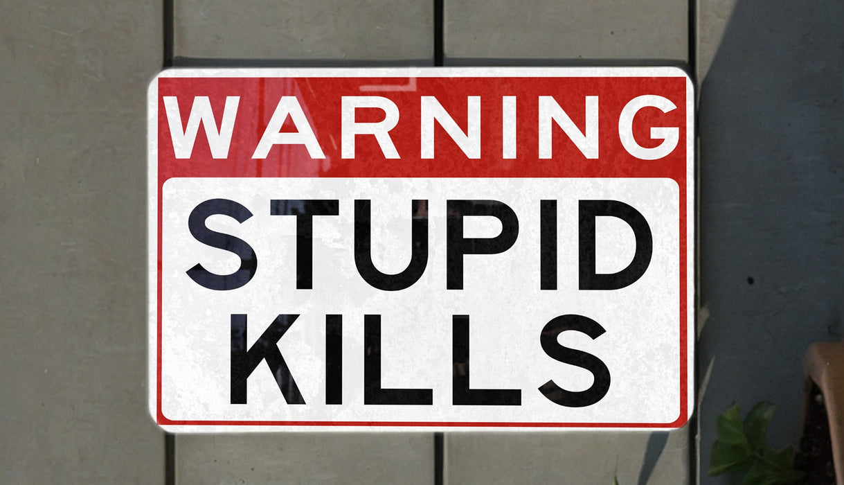 a red and white street sign hanging from the side of a building
