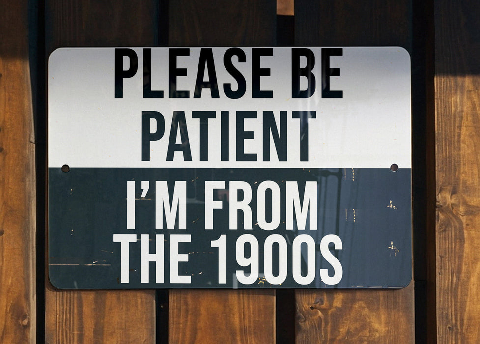 a black and white sign on a wooden fence