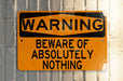 a yellow and black warning sign on a metal pole