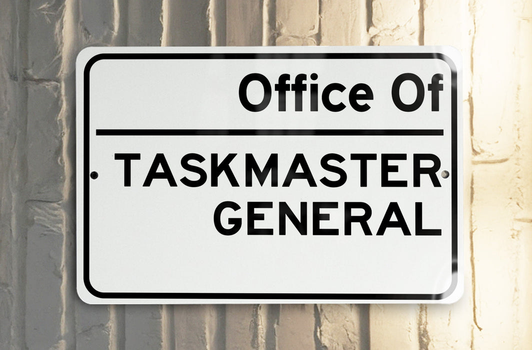 a white and black street sign hanging from the side of a building
