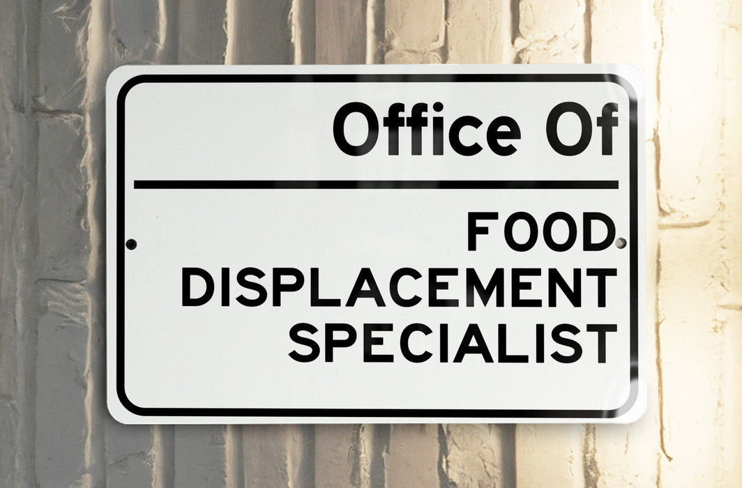 a white and black street sign on a pole