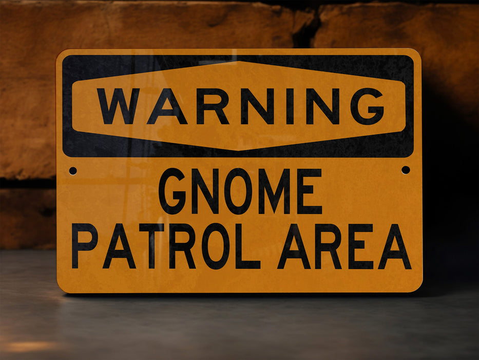 a warning sign on a concrete surface warning of gnome patrol area