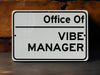 a white sign that says office of vibe manager