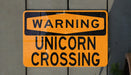 a close up of a street sign on a building