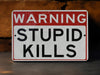 a red and white sign warning of stupid kills