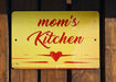 a yellow sign with red writing on a wooden fence