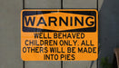 a yellow and black sign on a wall