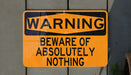 a yellow and black warning sign on a wall
