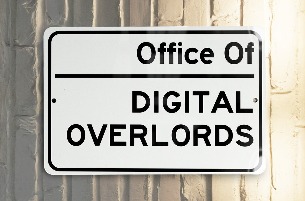 a white and black street sign hanging from the side of a building