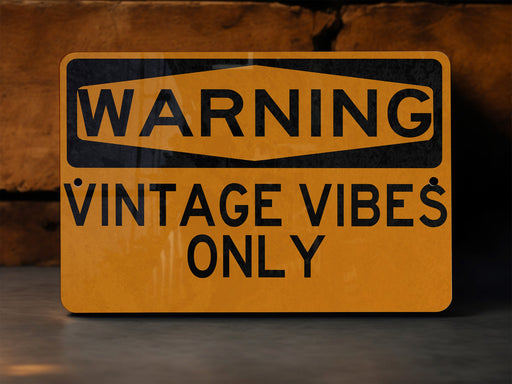 a yellow warning sign that reads warning vintage vibes only