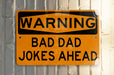 a yellow and black sign on a metal pole