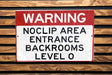 a red and white sign on a wooden wall