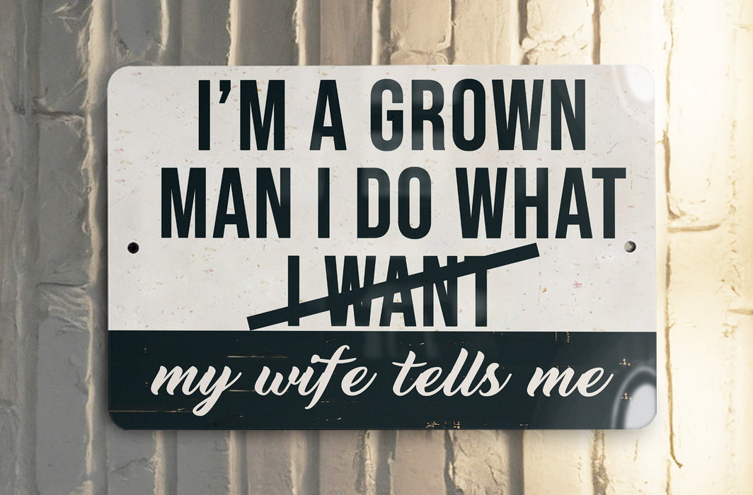 a white and black sign on a white wall