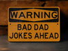 a yellow warning sign that says, warning bad dad jokes ahead