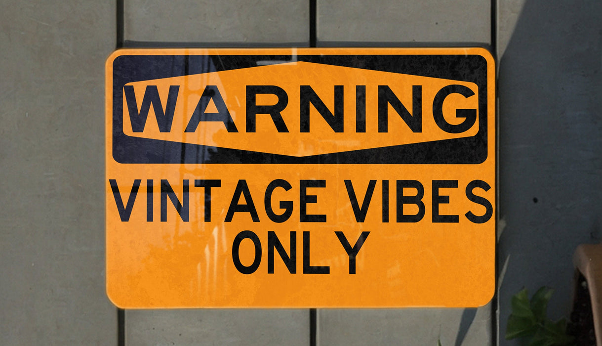 a yellow and black sign on a wall