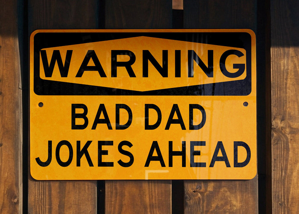 a yellow and black sign on a wooden fence