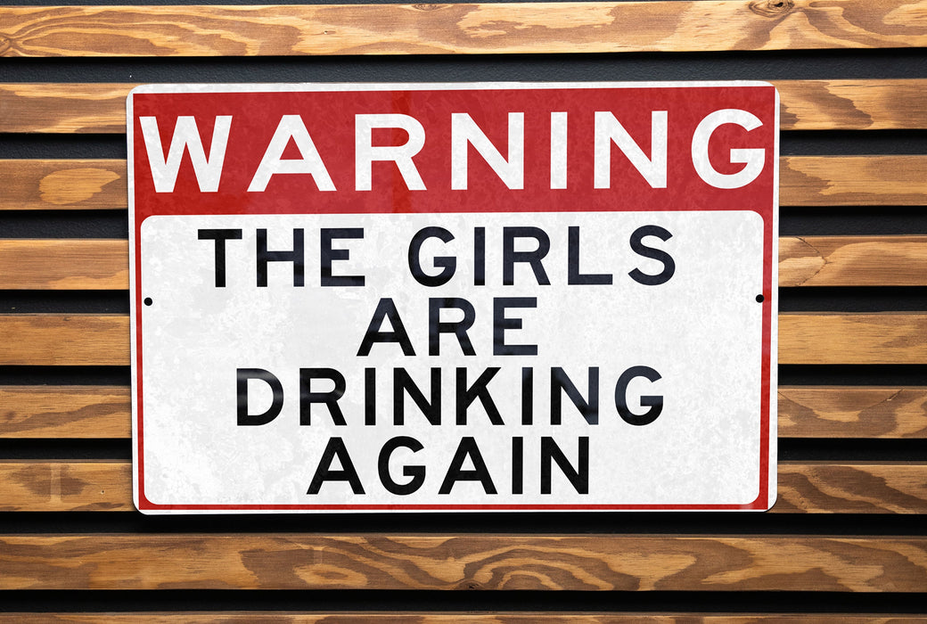 a red and white sign on a wooden wall