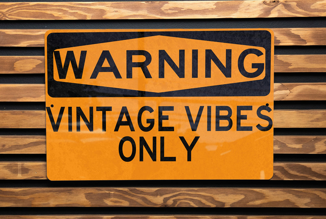 a close up of a street sign on a wooden surface