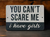a sign that says you can't scare me i have girls