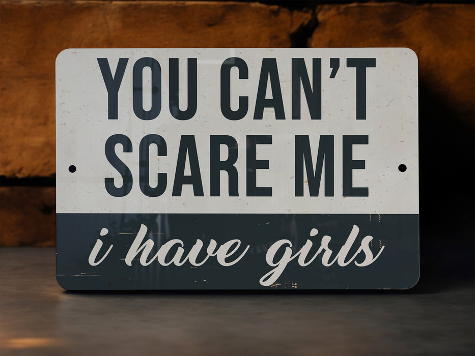 a sign that says you can't scare me i have girls