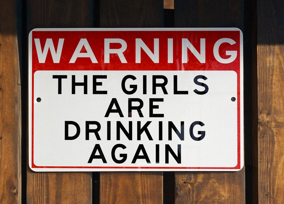 a red and white sign on a wooden fence