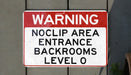 a red and white sign that says no parking