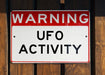 a red and white sign that is on a wooden fence
