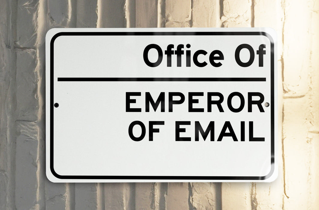 a white and black street sign hanging from the side of a building