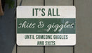 a green and white sign that says it's all shits & giggles