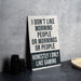 a sign sitting on top of a table next to a cup