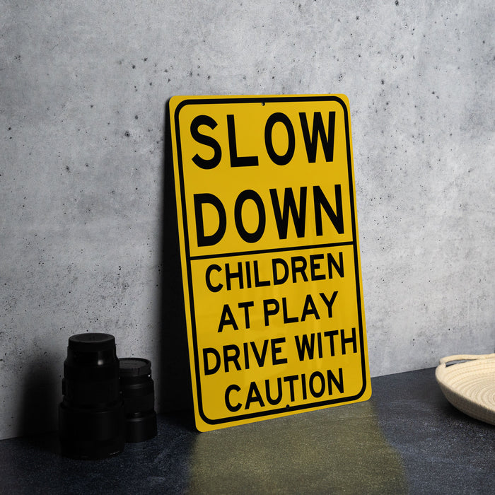 a yellow slow down sign sitting on top of a table